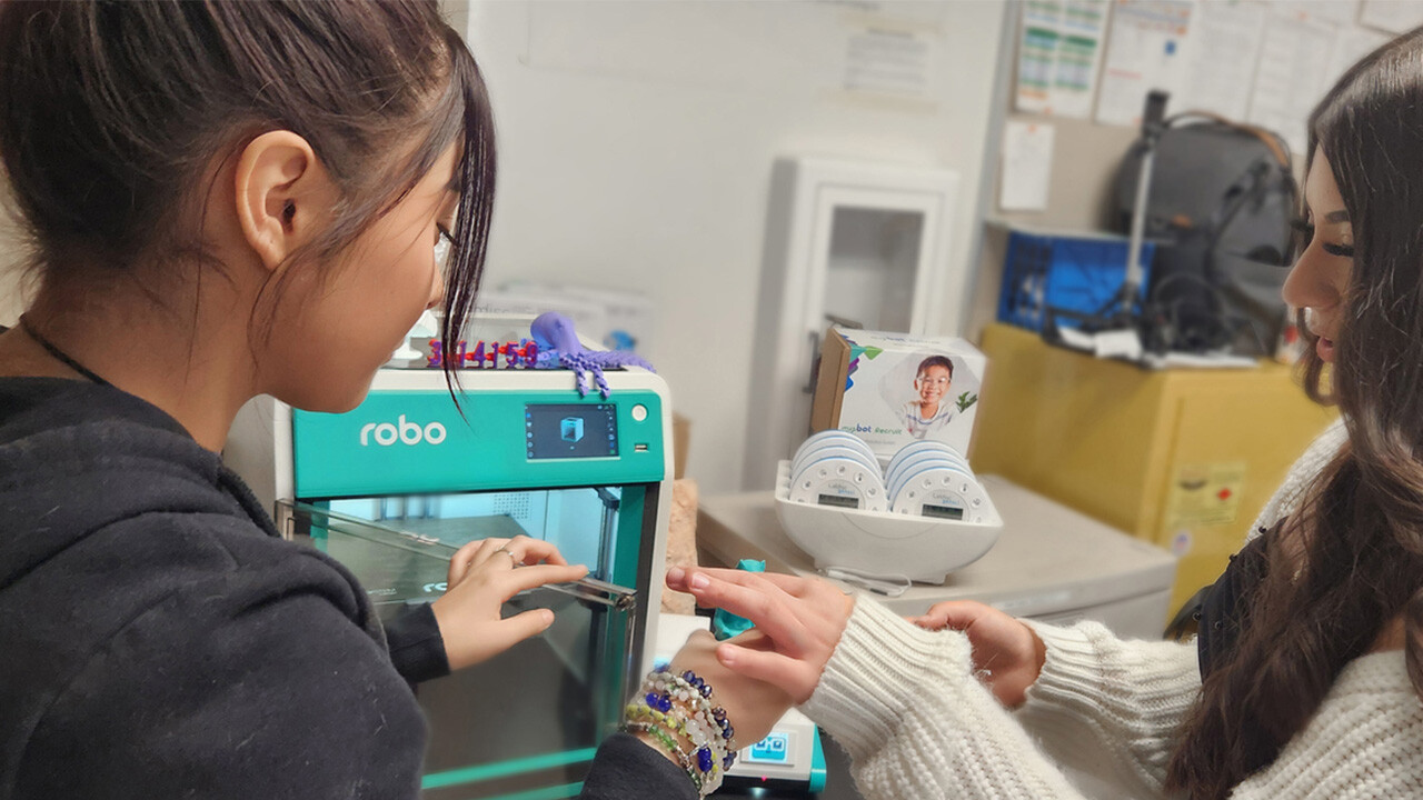 Two students inspect Boxlight Robo 3D printed object