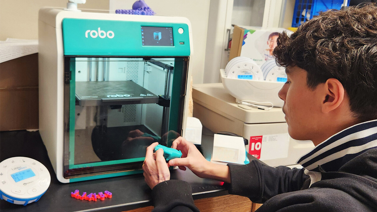 STudent removes 3D printed pig from Boxlight Robo E4 3D Printer