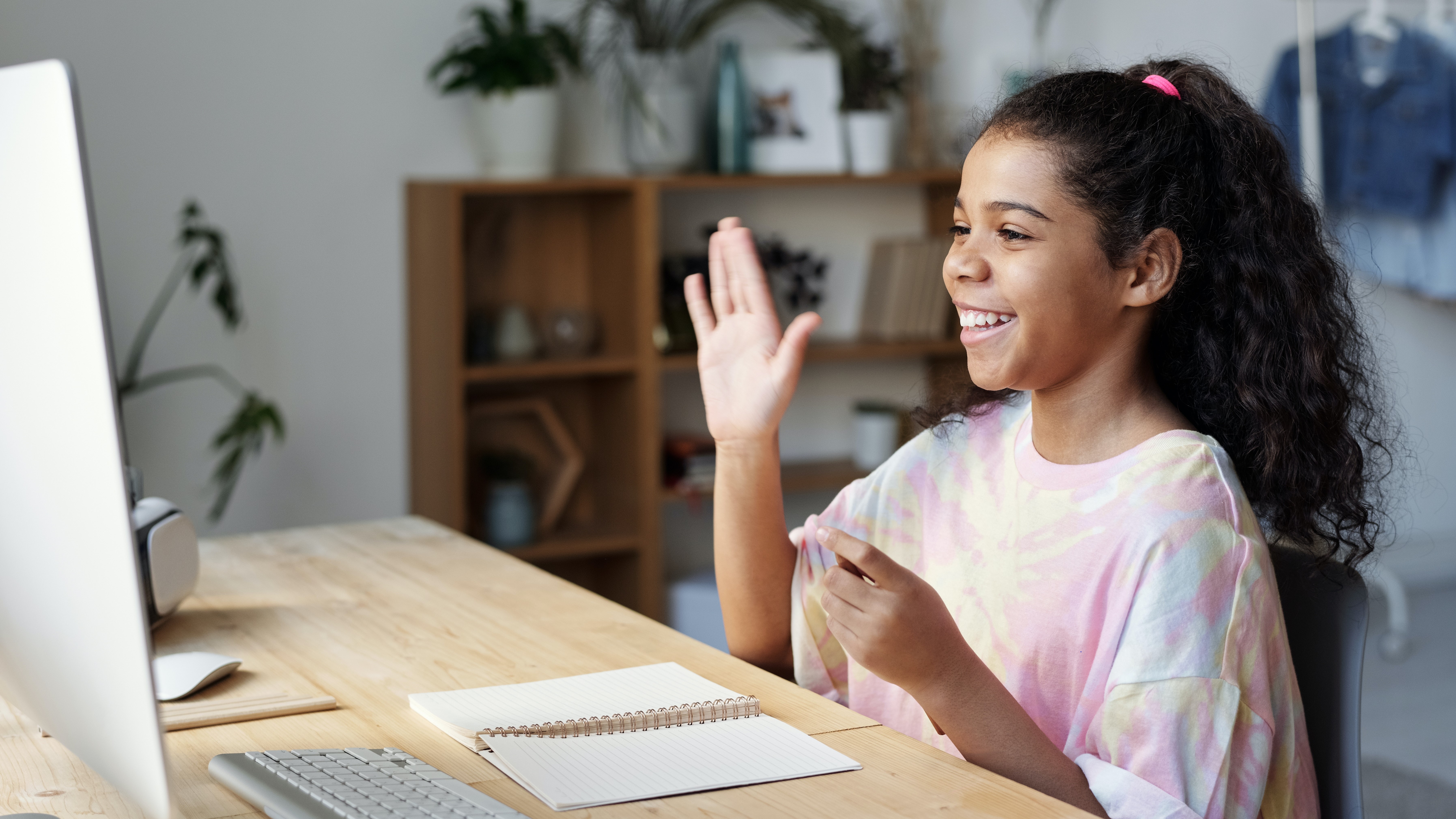 smiling girl raising hand
